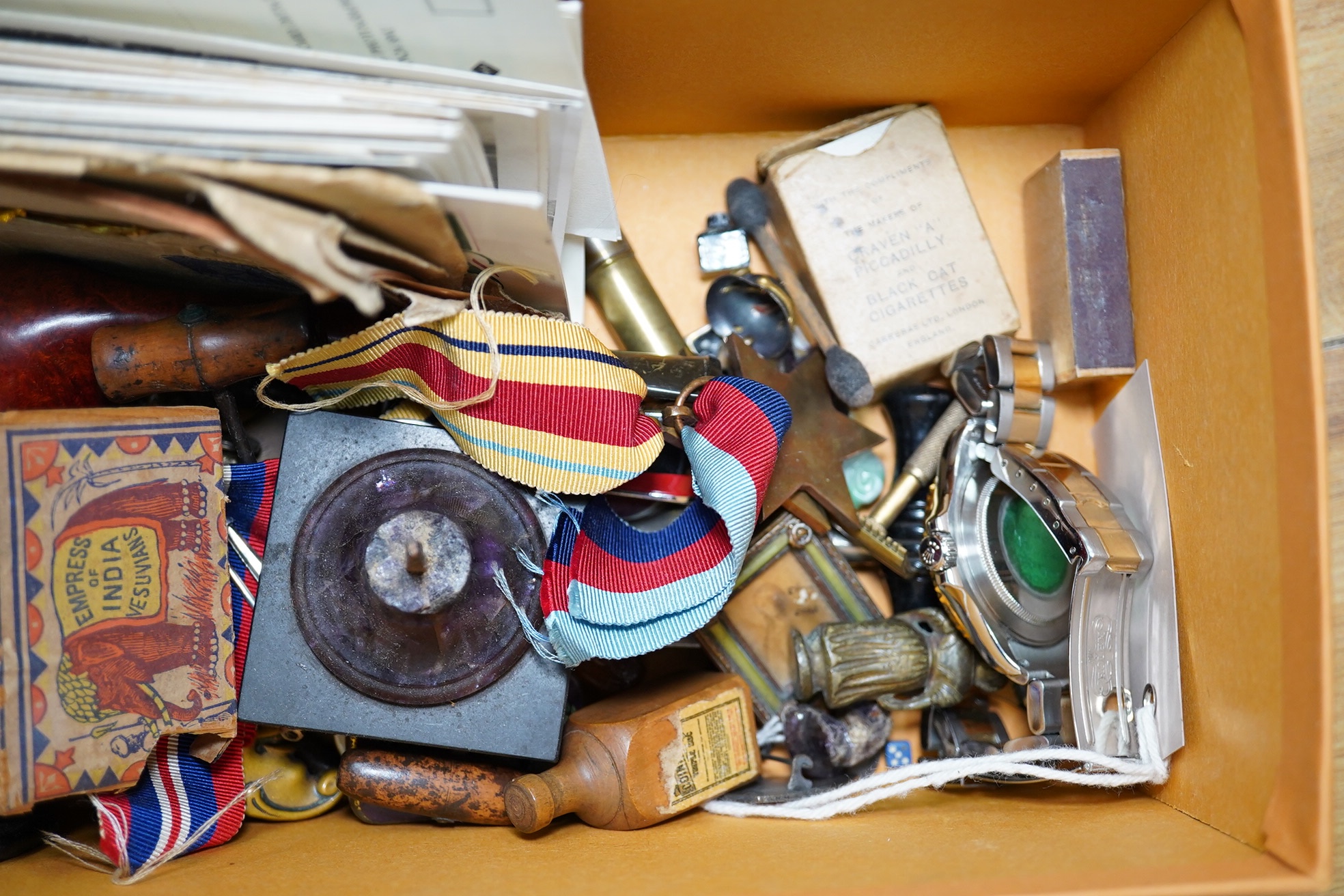 A box of assorted curiosities including vesta cases, one in the form of a skull, medals, section of Japanese inro and miniatures. Condition - varies